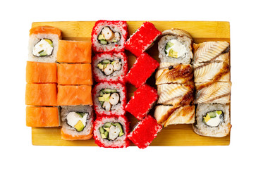 Top view set of classic california, philadelphia and eel sushi rolls on wooden board isolated at white background.
