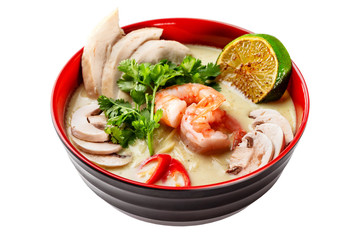 Bowl of thai tom yum soup isolated at white background.