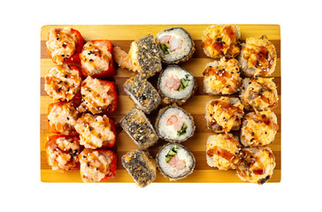 Top view set of hot sushi rolls with lava maki topping on wooden board isolated at white background.