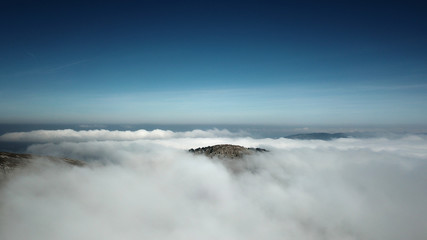 The summit of Pointe de Poêle Chaud (1628m) peaking through the clouds near La Dôle in the Jura mountain.