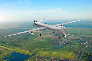 Unmanned military drone on patrol air territory at low altitude.