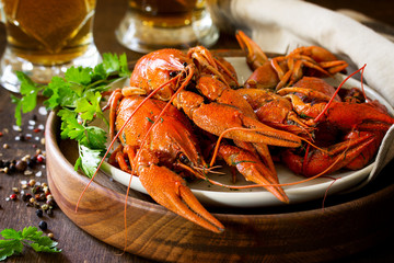 Boiled Crawfish and Fresh Beer in Beakers on a wooden table. Appetizer protein.