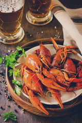 Boiled Crawfish and Fresh Beer in Beakers on a wooden table. Appetizer protein. Toned image.