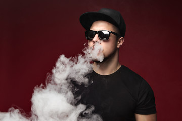 Vaping man and a cloud of vapor