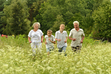 Older man and woman with their grandchildren