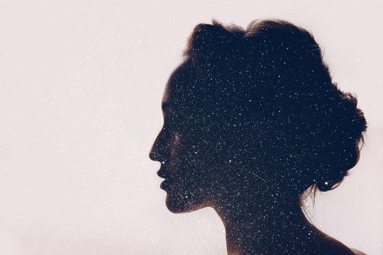 Girl and space. Silhouette and starry sky.