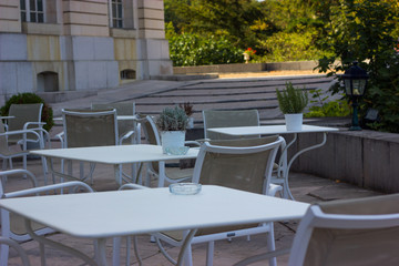 white coffee tables on the street with flowers