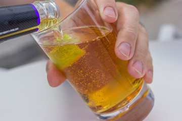 carbonated beverage of amber color with lime in a glass goblet