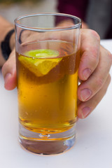 carbonated beverage of amber color with lime in a glass goblet
