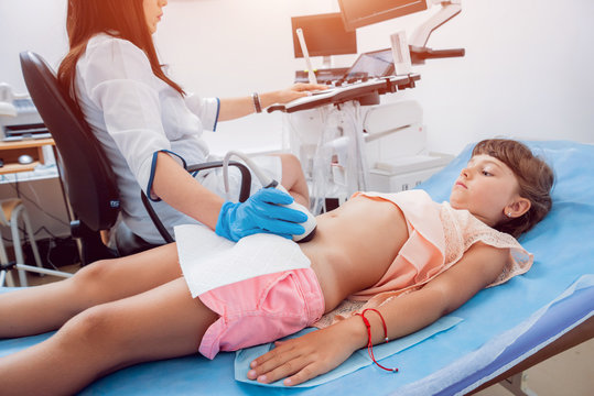 Medical exam of a little girl by ultrasound equipment