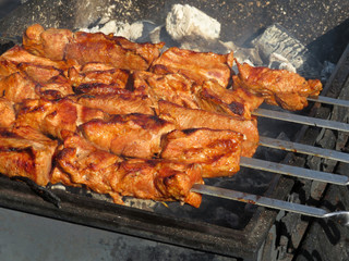 Kebabs frying on an open fire, shashlik on charcoal. Meat cooking on the grill