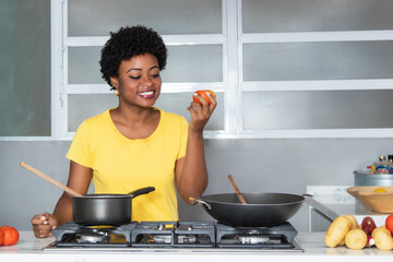 African american woman cooking with tomato