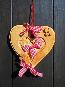 Wooden heart with red and white bow