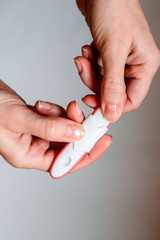 Pregnancy test in woman's hand. Shallow depth of field.