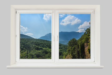 View from the window. Mountain forest landscape under evening sky