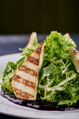 A mountain of greenery, arugula, lettuce with an abundance of unusual berry, blueberry sauce. Thin slices, chicken, white meat, fish, grilled. Dietary salad for those who lose weight.