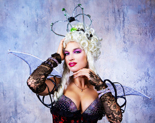  model wearing Halloween costume of a queen, in the studio