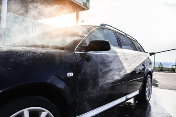 High-pressure washing car. Car washing under the open sky.