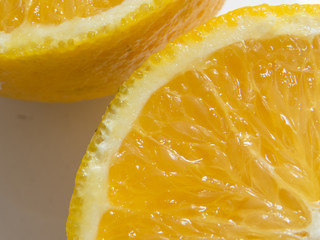 Close detail of half cut juicy orange on white background with shadow. Healthy and refreshing...