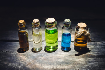 Various magic potions or colorful essential oils in the bottles on the table.