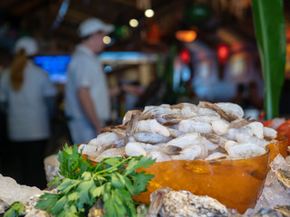 Pile of uncooked white shrimp waiting to be prepared by chefs at restaurant