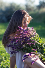 Perfect woman with lilac flowers bouquet