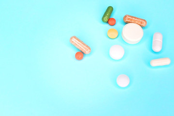 Tablets from a bottle on a blue background