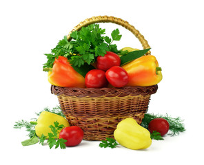 Fresh peppers, tomatoes, greens in a basket. Isolated on white. Diet, proper nutrition. Vegetables.