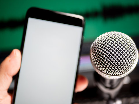 Microphone And Phone With White Screen With Space In Front Of Editing Program On Screen. First Person View