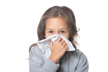 Portrait of sick little girl holding handkerchief