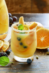 Summer drink with peaches, oranges and blueberries.