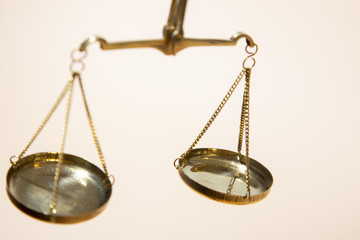 Gold scales of justice on brown background
