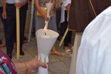 Bearer of lcandle for the patronal feast.