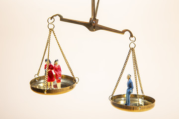 Depicted in a conceptual image by  a seesaw showing the male and female genetic symbols in...