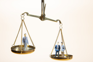 Balance between boss and employee on gold scale