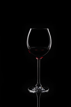 Glass of red wine at black background
