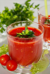 Fresh tomato juice with tomatoes and greens.