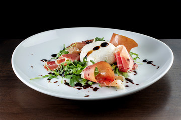 Salad with bacon and soft cheese. It is decorated with sauce-2.