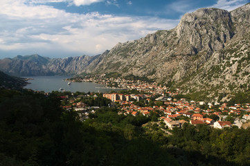 Fototapeta na wymiar Overlooking city of Kotor and Bay of Kotor (Boka Kotorska) with the mighty massive mountains at the back