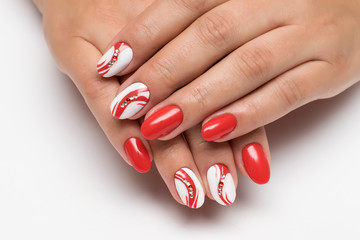 bright summer red white manicure with crystals, painting on oval nails on a white background steep