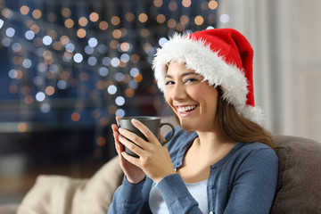 Happy woman holding a cup on chistmas at home
