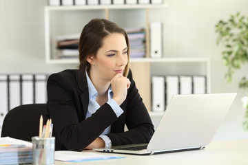 Pensive businesswoman with a laptop at office