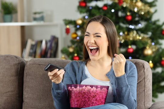 Excited Woman Watching Tv On Christmas