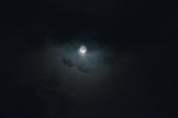 Autumn full moon surrounded with clouds