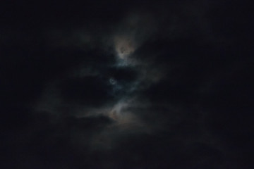Naklejka na ściany i meble Full moon behind clouds