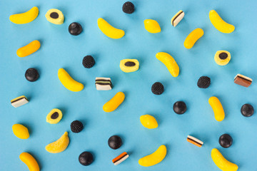 Variety of colorful candy pattern on blue background.