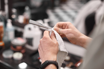 Haircut and hair styling in barbershop. Hair Care. Men's style and lifestyle. Barber brings a haircut and beard to his client.