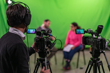 Interview recorded in a chroma with two cameras and one cameraman in frame