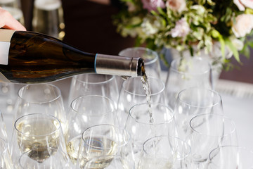 Waiter pouring champagne in the party event. Reception at the wedding party or Banquet for the anniversary