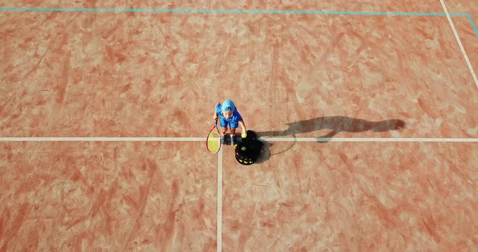 Little boy playing tennis. Little boy in tennis serving. Aerial view.